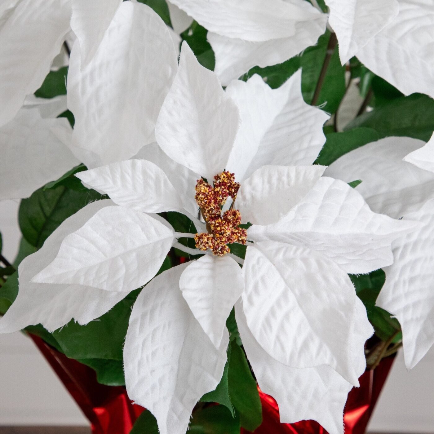 19" Artificial Lush White Poinsettia Arrangement in Red Wrapped Planter